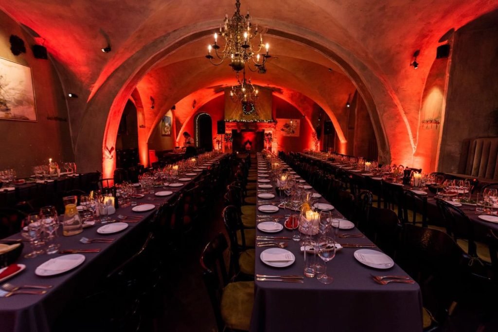 La Boheme Vilnius main room prepared for event with long tables