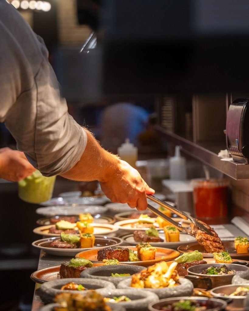 Momo Grill Vilnius in the kitchen preparing food for a group