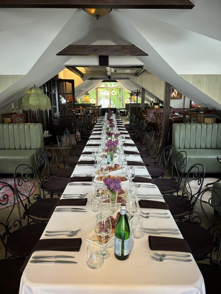 Old Green House Vilnius set up for group dinner in third floor